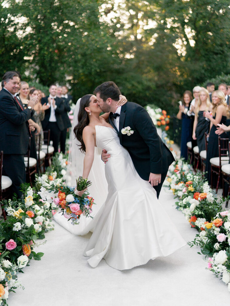 bride and groom kissing after wedding ceremony